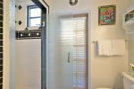 Bathroom with custom shower and door leading to private outdoor shower